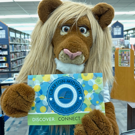 roary holding giant card in the building